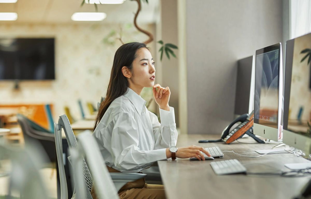 A busy entrepreneur happily delegating tasks to a professional virtual assistant on a laptop, surrounded by neatly organized icons representing tasks like email, calendar, social media, and data entry, symbolizing increased productivity and efficiency.